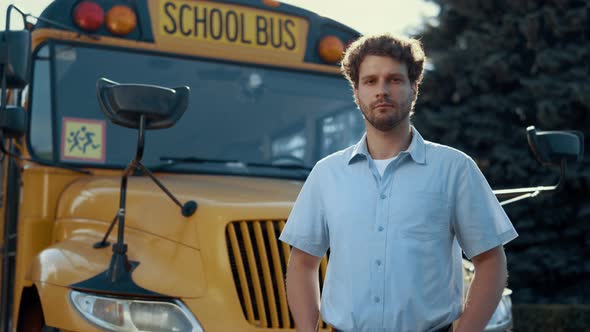 Portrait Schoolbus Driver Standing at Yellow Vehicle Alone Looking Camera