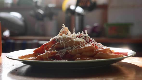 Sprinkle Pasta with Grated Cheese in Slow Motion