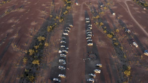 Tilt-up and push-in over an Arizona desert with parked RV campers at sunset