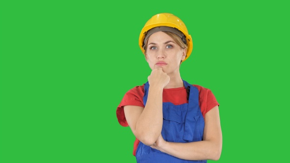 Thinking construction worker woman wearing builder helmet