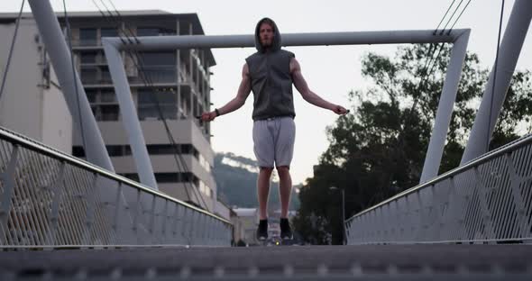 Sporty Caucasian man training on a bridge