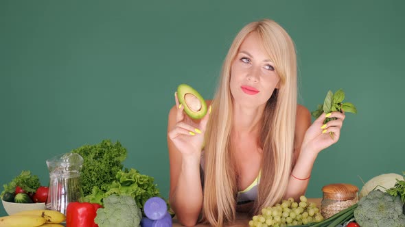 Girl Trying To Choose Between Avocado And Lettuce