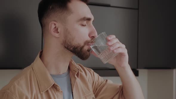 a Man Drinks Water From a Glass Maintaining the Water Balance in the Body