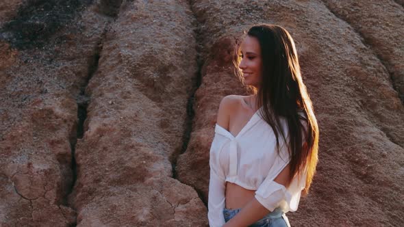 Beautiful woman posing on other-worldly hilly landscape