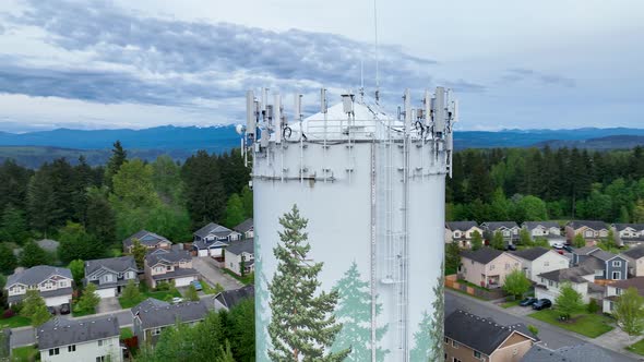 Tight aerial shot of the cell phone tower equipment on top of a water tower.