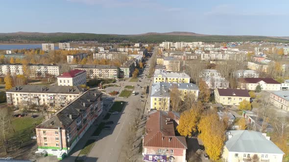 Aerial view of a square in the provincial Russian city with low buildings. Autumn sunny day 42