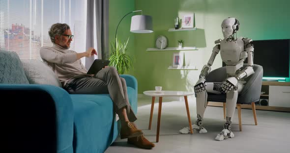 Mature Man Controlling Robot at Home