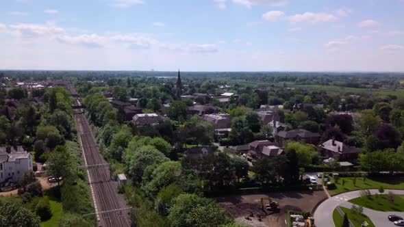 Drone flying over urban landscape in Alderley Edge, Cheshire, UK  - showing suburban greenbelt and a