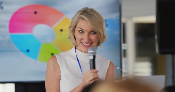 Female speaker taking questions from the audience at a business conference