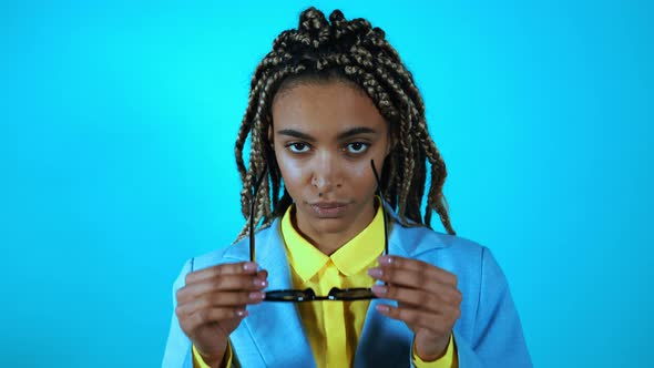 Woman with braids acting on a colored background