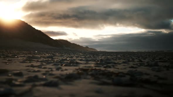 Sunset Over Pebbles On Beach