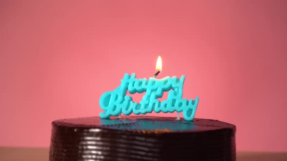 Birthday Cake with Lighting Candle Confetti Falling Down on Background