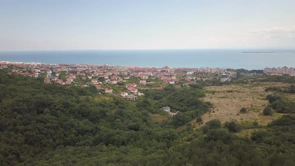 Aerial view of Sunny Beach city that is located on Black Sea shore. Top view of sand beaches with