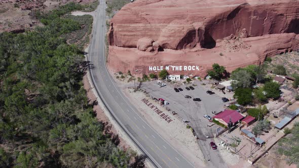 Touristic Hole in the Rock Roadside Attraction in Southwest US Desert - Aerial