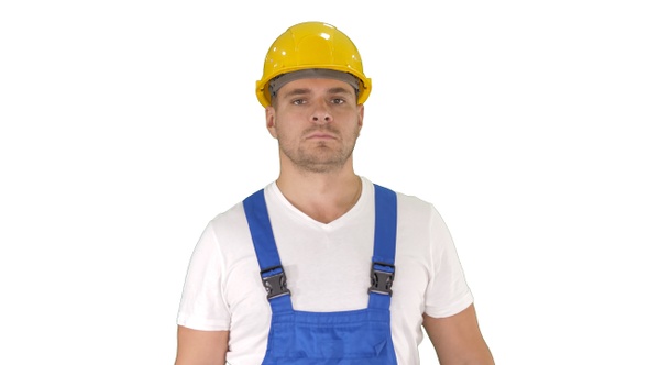 Builder walking and looking to camera on white background.