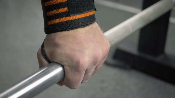 Athlete in Gym Lifts the Barbell