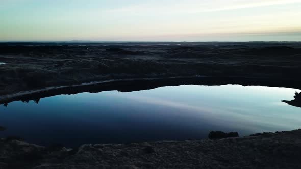 Blue Sky Reflecting in Western Ocean Surrounded By Sandy Shores