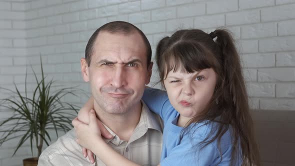 Portrait of a cheerful father and daughter