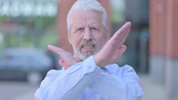 Outdoor Old Man Saying No with Arm Cross Sign