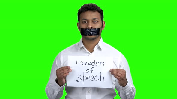 Businessman with Taped Mouth on Chroma Key Background