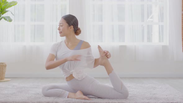 Side view of Asian woman doing Yoga exercise