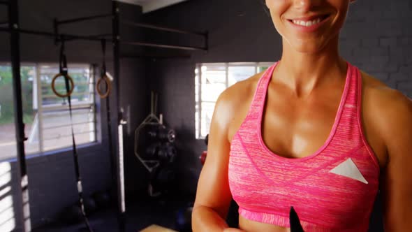 Beautiful fit woman wearing gym gloves