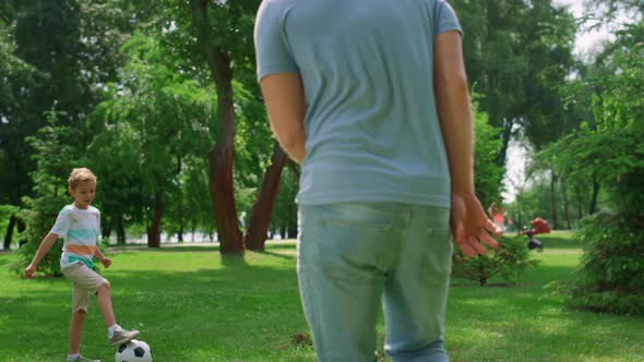 Boy Make Football Exercise with Father Closeup