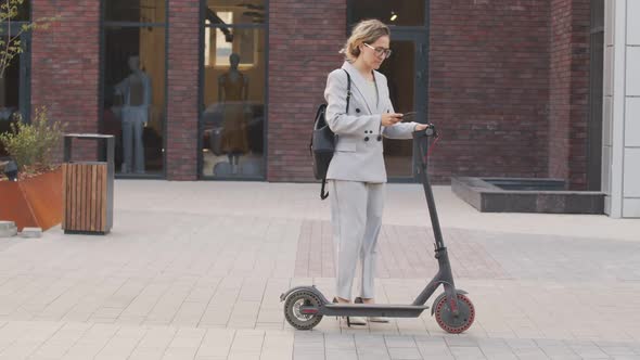 Businesswoman Riding Electric Scooter