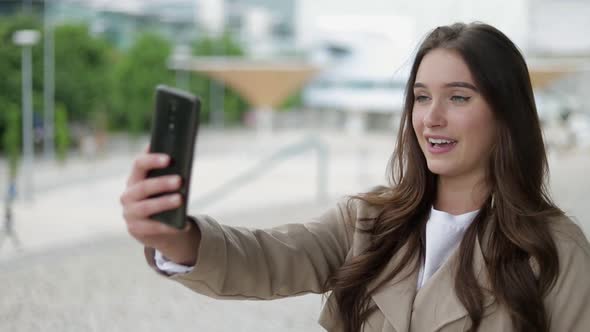 Caucasian Girl Having Video Chat on Phone Outside, Gesticulating