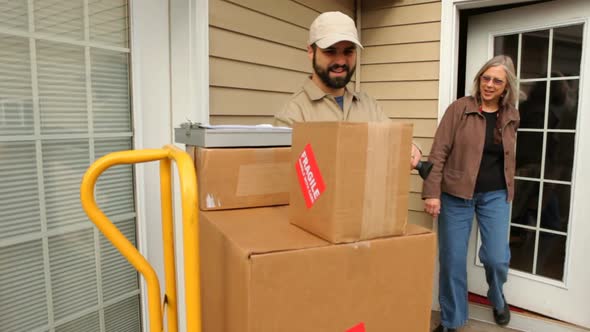 Man delivers packages to woman at home