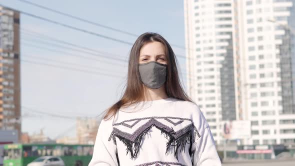 Portrait of a Young Student Woman Wearing Protective Mask on street.Concept of Health and Safety