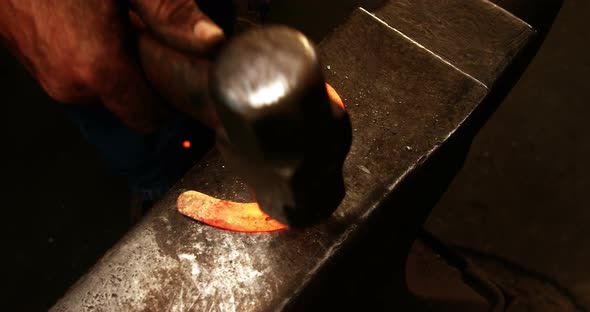 Blacksmith working on a horseshoe