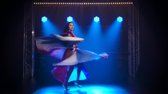 Slender High Girl Dancing in a Sexy Suit in the Color of the English Flag and Rhinestones