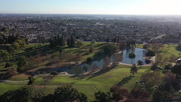 Drone shot flying over the lake at the La Mirada Regional Park.