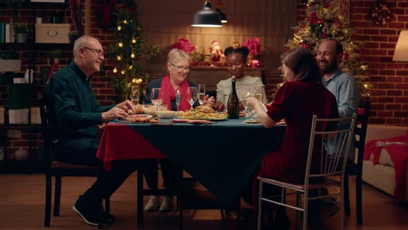 Positive Multicultural People at Home Enjoying Christmas Dinner