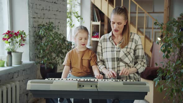 The Tutor Tells the Girl How to Play the Synthesizer