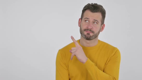 Portrait of Middle Aged Man Pointing Towards Product Display