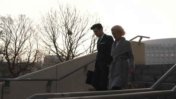 Man and woman going down the stairs