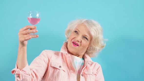 Happy Positive Grandma with Glass Looking at the Camera Celebrating Her Birthday