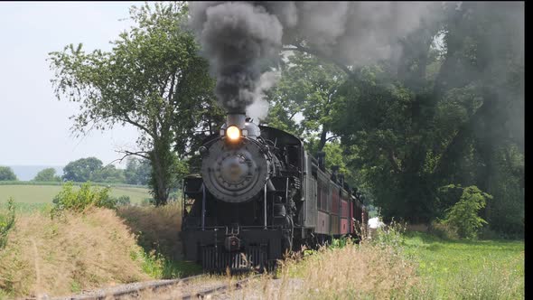 Steam Train Puffing Along Amish Countryside