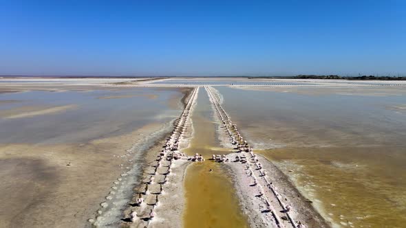 Abandoned Pier on Multicolored Lake Medicinal Clay Ungraded on Sunset, Air Drone View