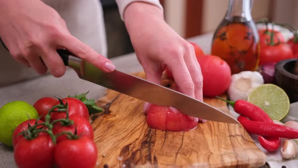 Woman Cutting Peeled Tomato Using Kitchen Knife