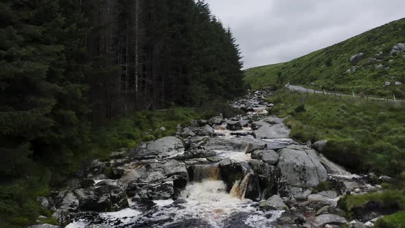 Glenmacnass River in The Wicklow Mountains, Ireland during a cloudy day.