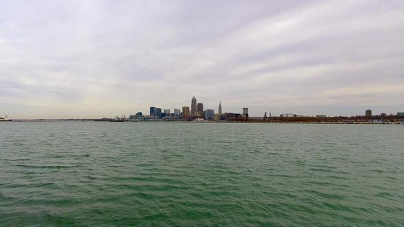 Wide drone shot of downtown Cleveland Ohio skyline and lake eire