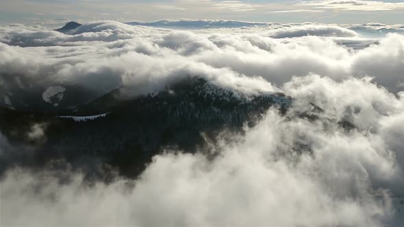 Foggy Morning Above Clouds Moving in Winter Mountains Landscape