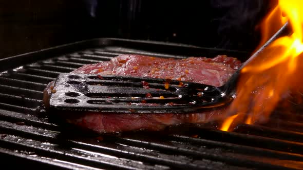 Spatula Presses the Steak on the Hot Surface