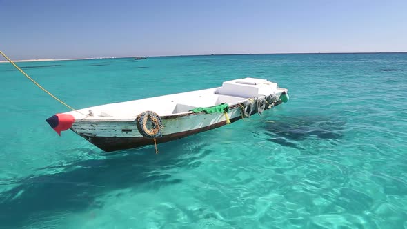 Little wooden boat floating in the Red sea, Egypt