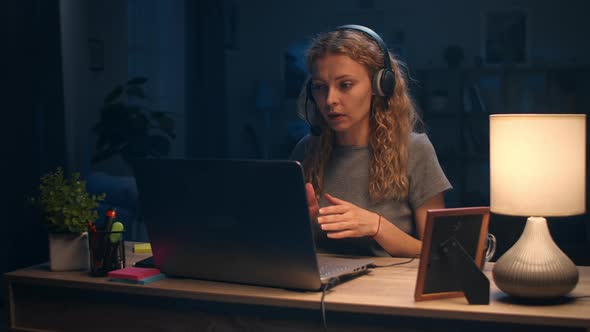 Young Woman Having an Online Chat Late at Night