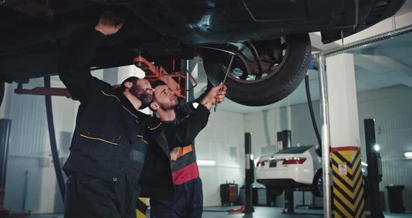 Good Looking Young Mechanic Guy and Main Mechanic