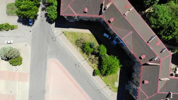 A red roof of the old building near a square